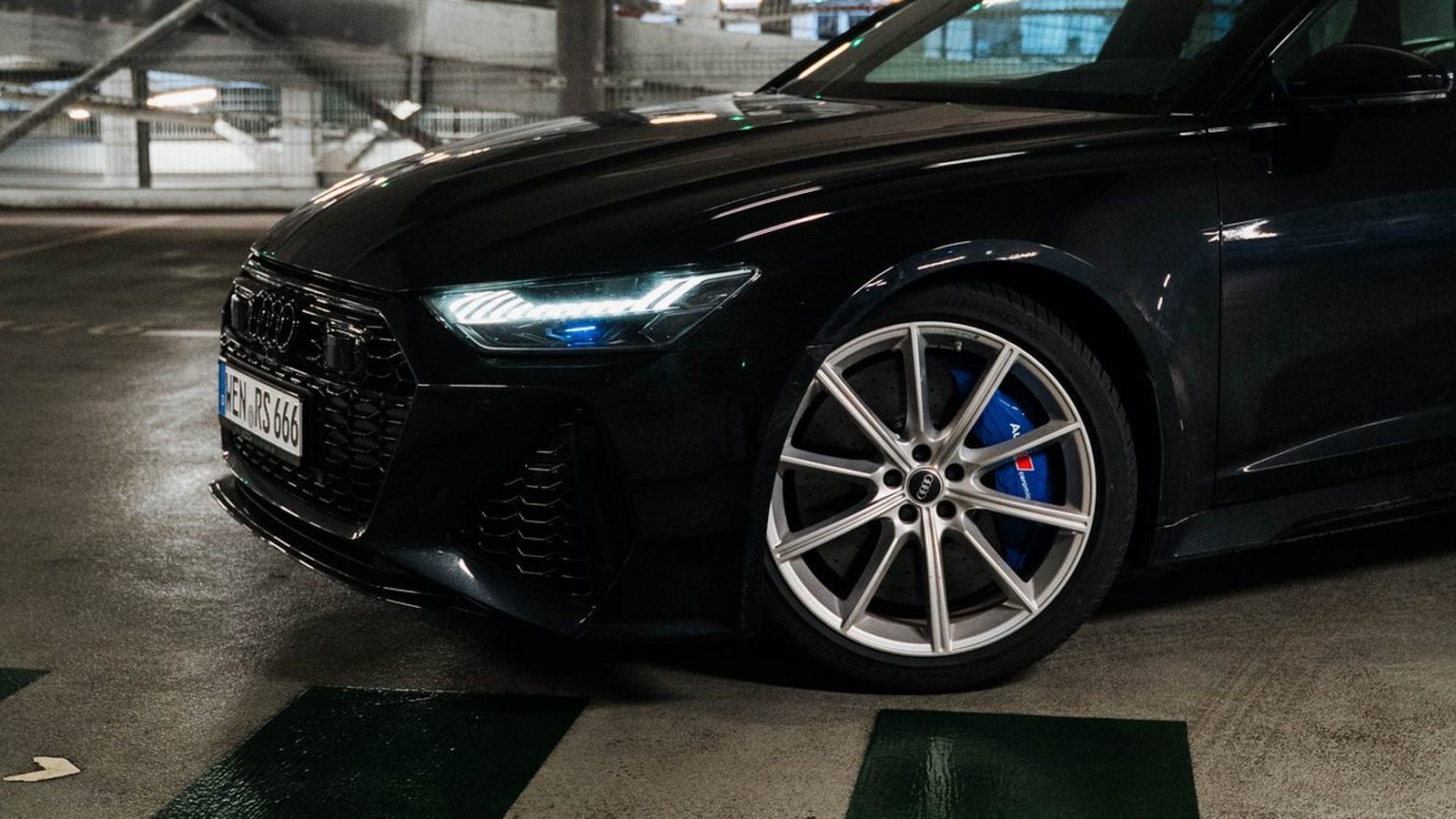 Black Audi RS6 Avant, front three-quarter view in a parking garage